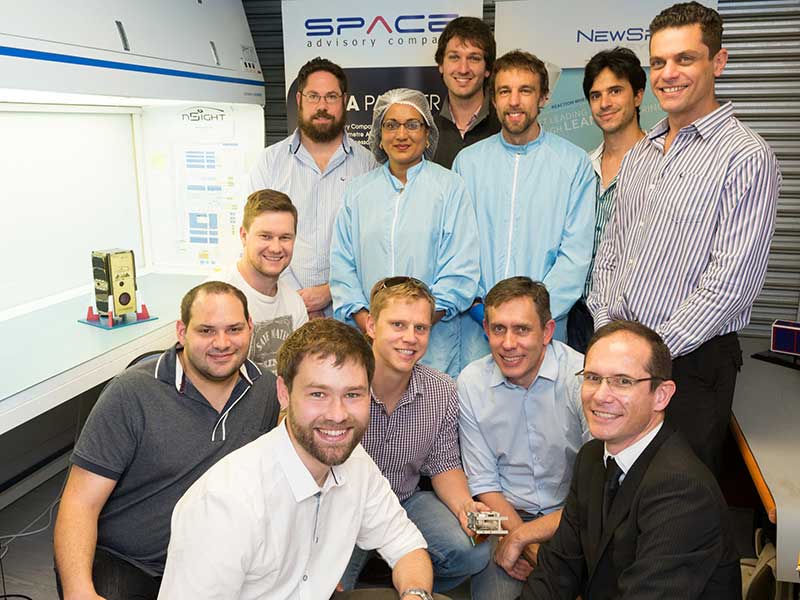 The core team that built SCS Aerospace Group's nSight1 nanosatellite are: (front from left to right): Dr Louis Muller, Dr Francois Malan, Kannas Wiid, Rikus Cronje, Hendrik Burger; (middle) David Brill; and (back row) Heinrich Fuchs, Premie Pillay, Philip Bellsted, Dr Lourens Visagie, Kevin Gema and Marcello Bartolini. (Image: SCS Aerospace Group)